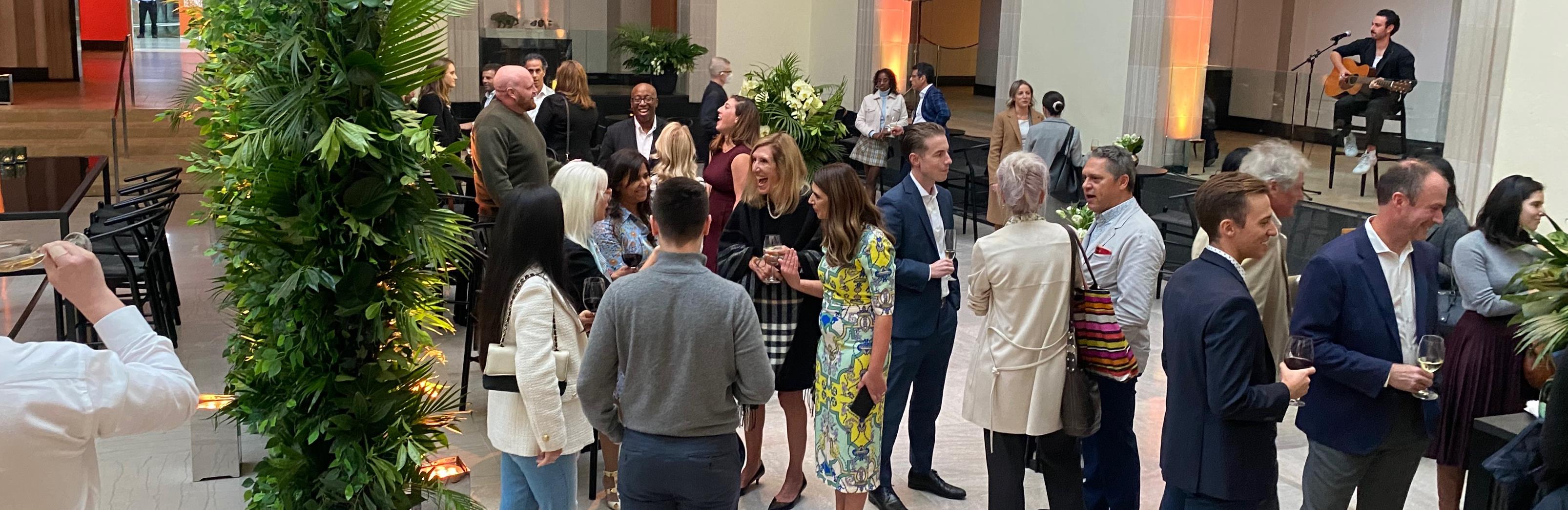 People interacting in a social event  using social clothes  and laughing