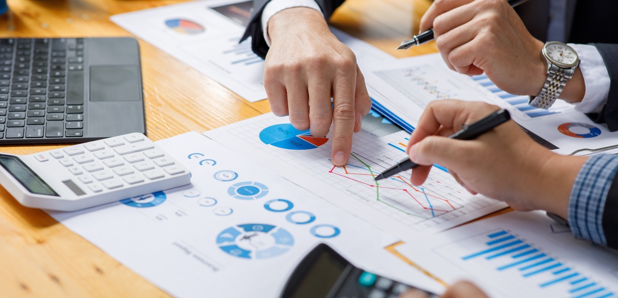 Business man hands hold documents with financial statistic stock photo, discussion, and analysis report data the charts and graphs.