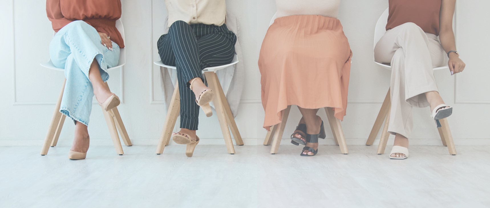 Women sitting on chairs with only their waist down showing