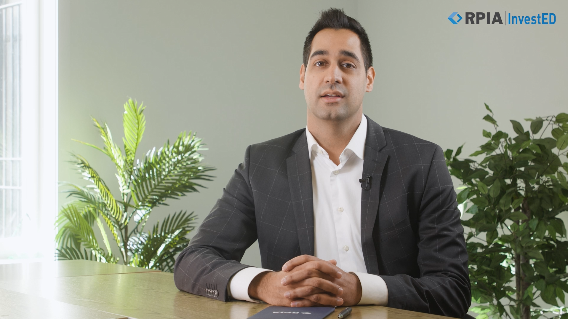 Imran Dhanani in a boardroom with  plants in the background