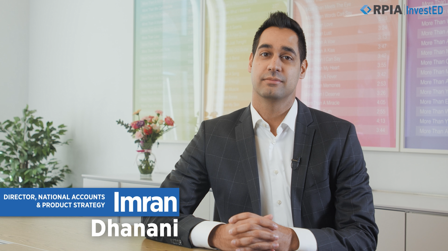 Imran Dhanani sitting at a boardroom table